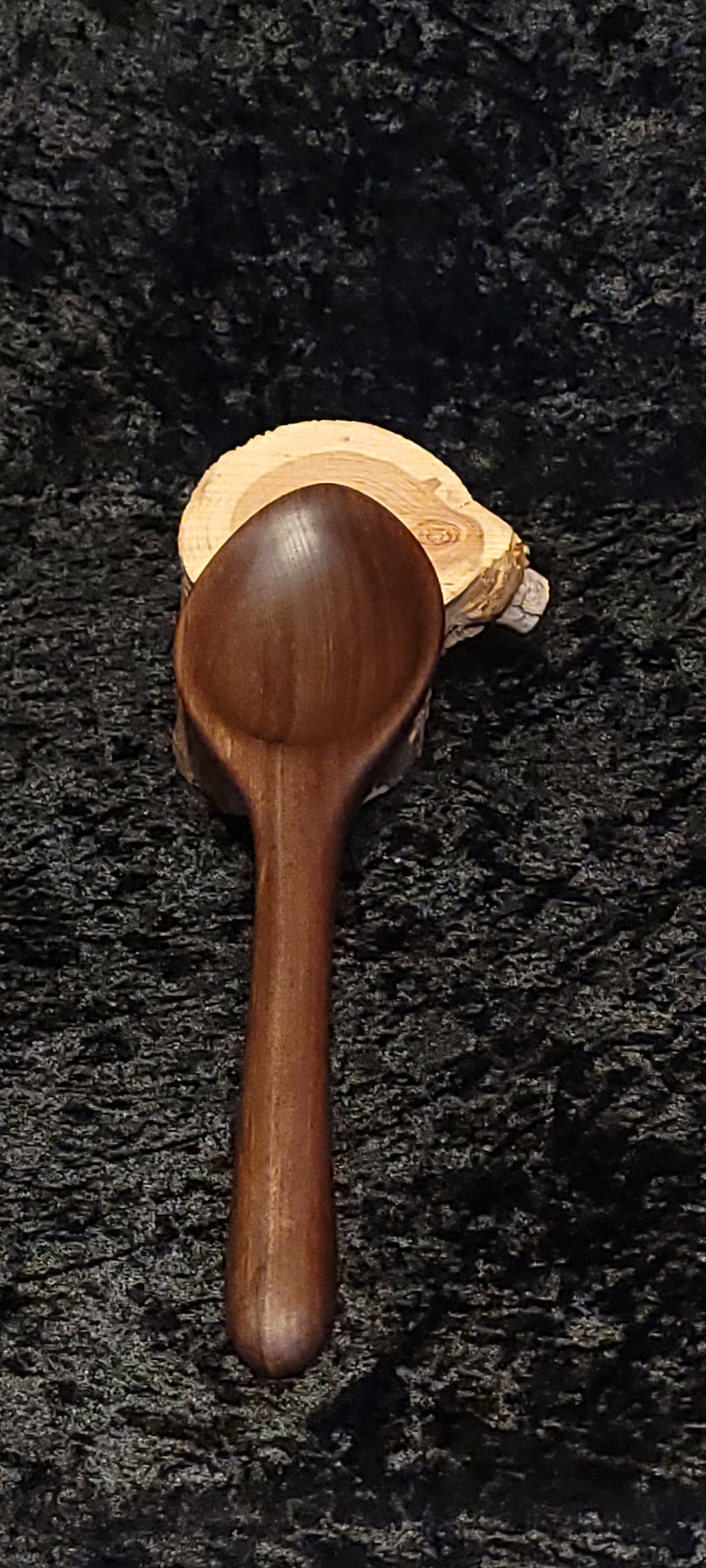 Walnut wood spoon held in hand