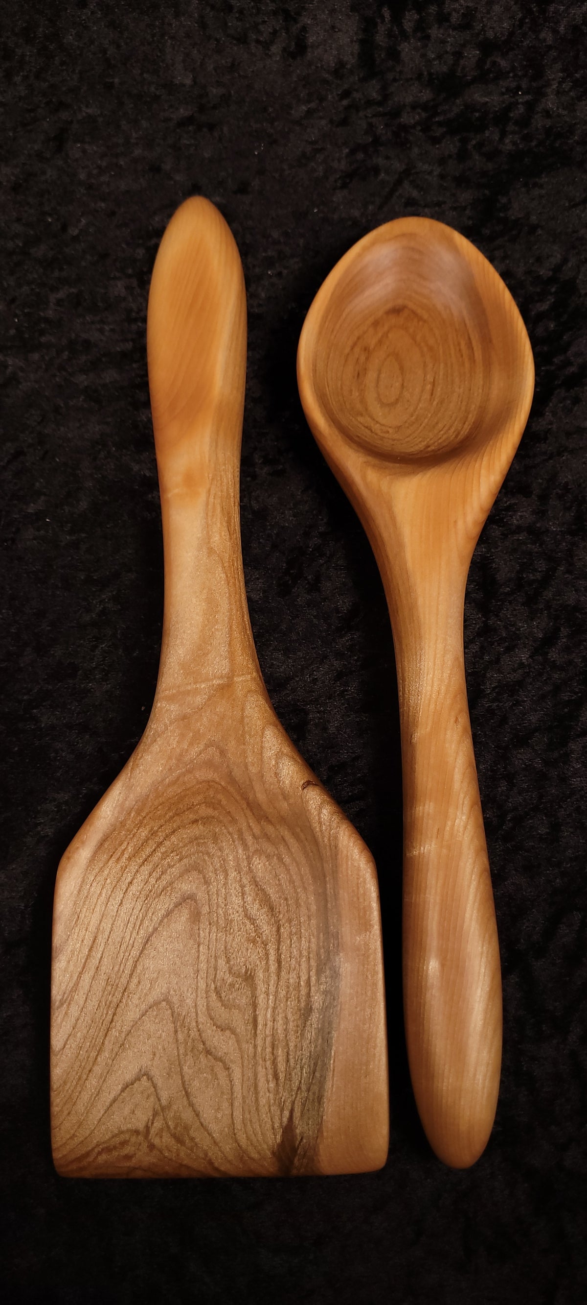Curly maple wide spatula front view on wood round