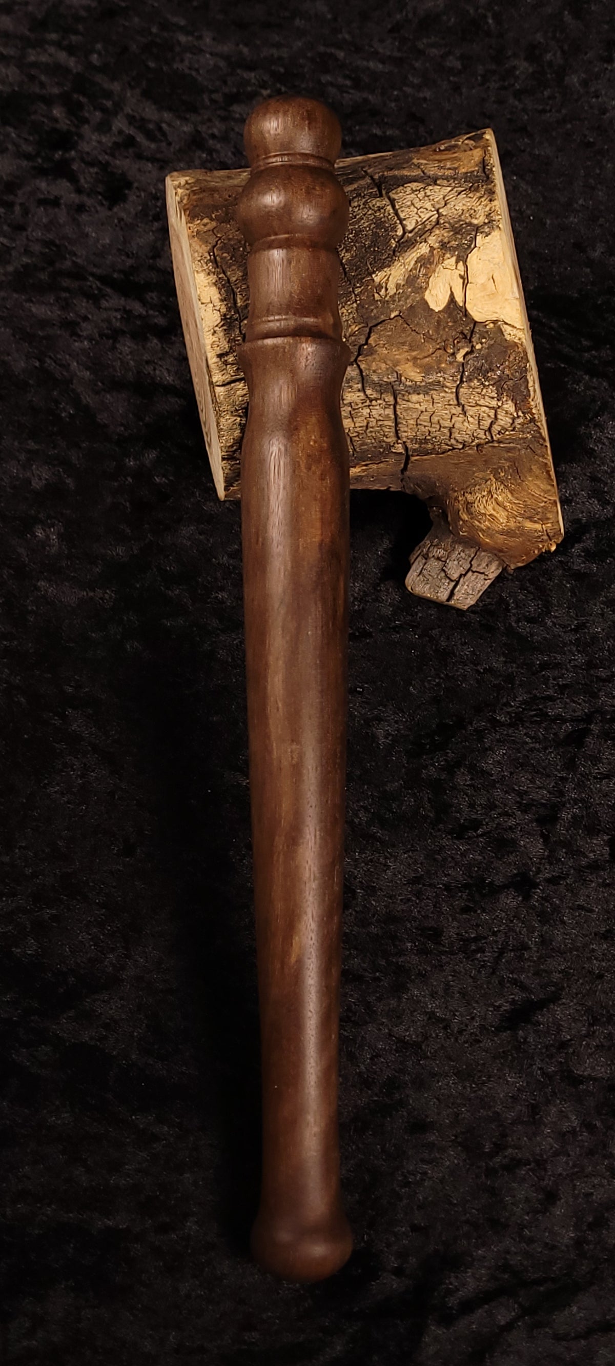 Walnut spurtle with spalted head front view on dark background
