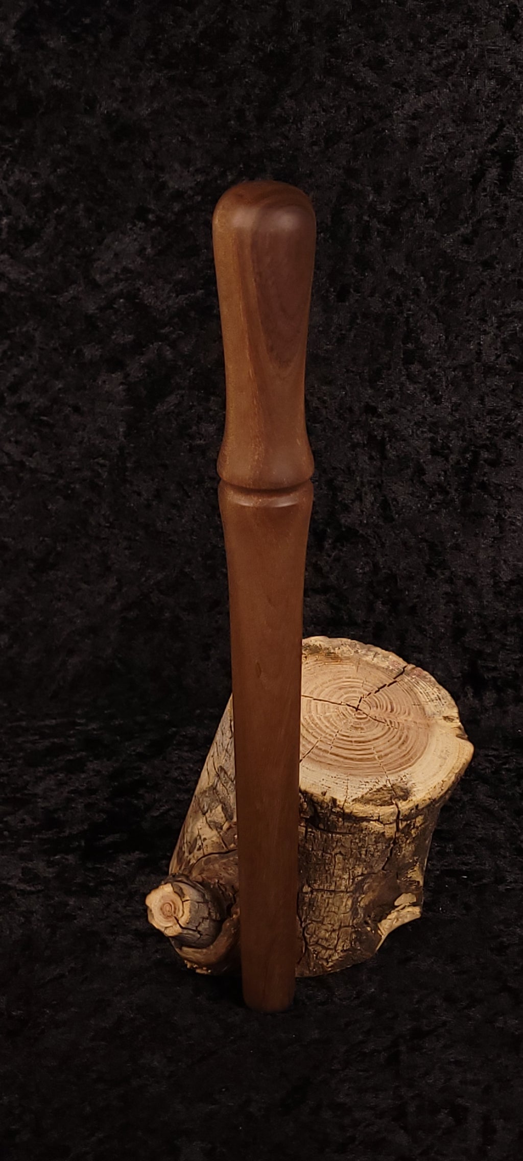 Walnut spurtle standing on spalted wood round