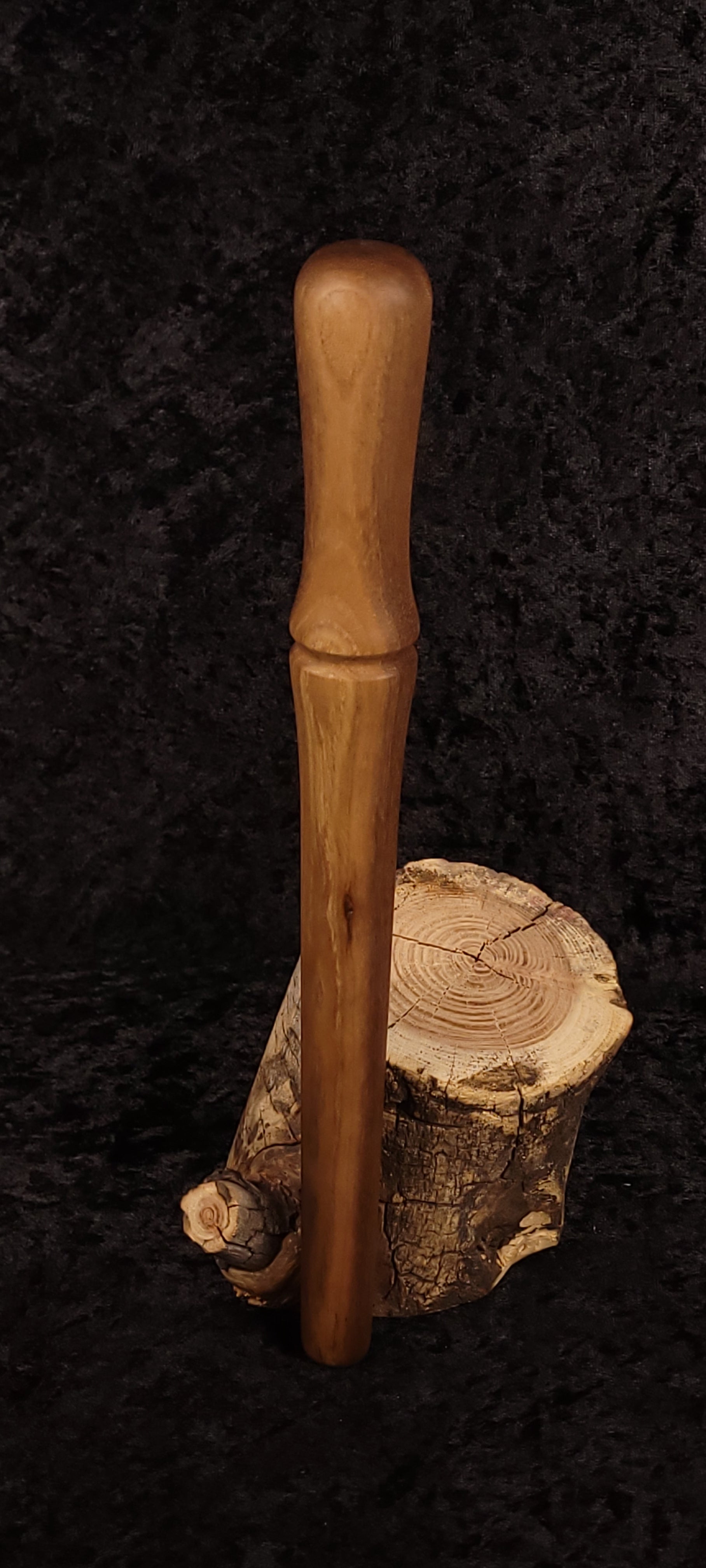 Walnut spurtle side view on spalted wood round