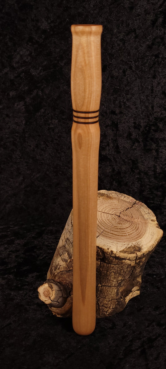 Curly maple spurtle front view on dark background