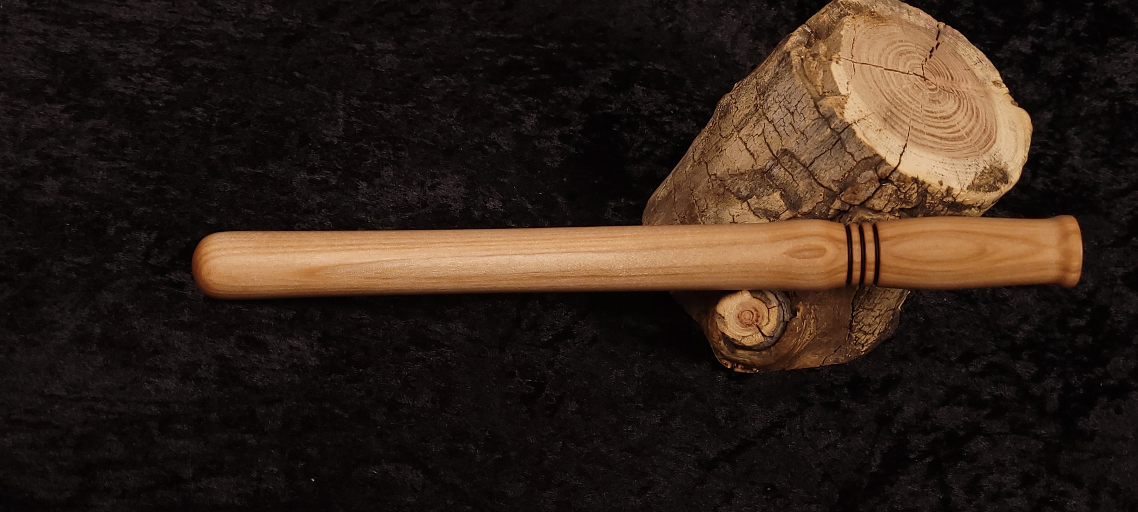 Curly maple spurtle horizontal view on spalted wood round