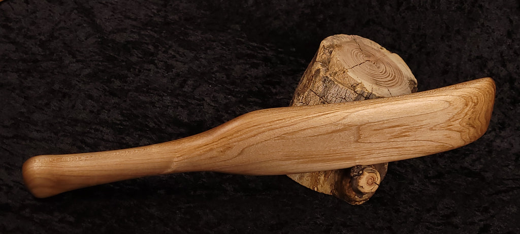 Curly maple spatula opposite side horizontal on log