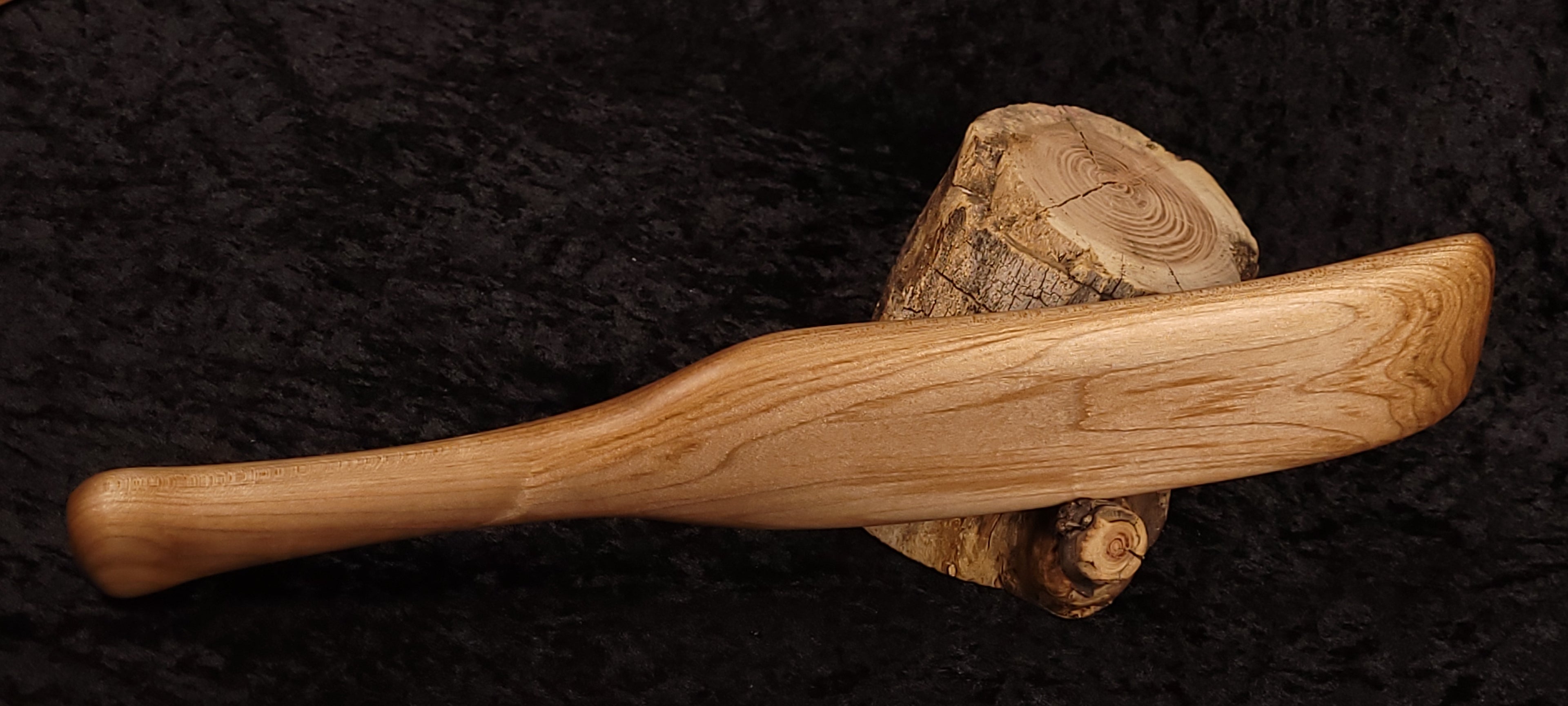 Curly maple spatula opposite side horizontal on log