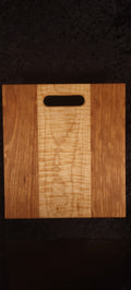 Cherry and curly maple cutting board, front face showing figured maple center stripe