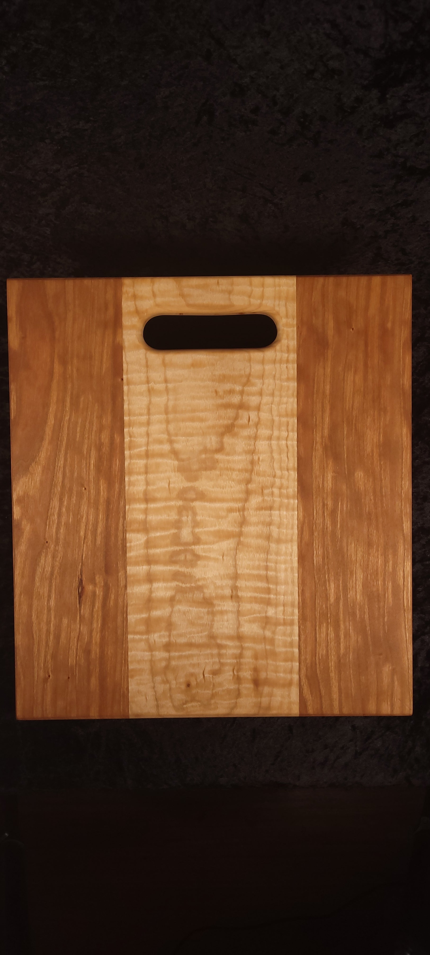 Cherry and curly maple cutting board, front face showing figured maple center stripe