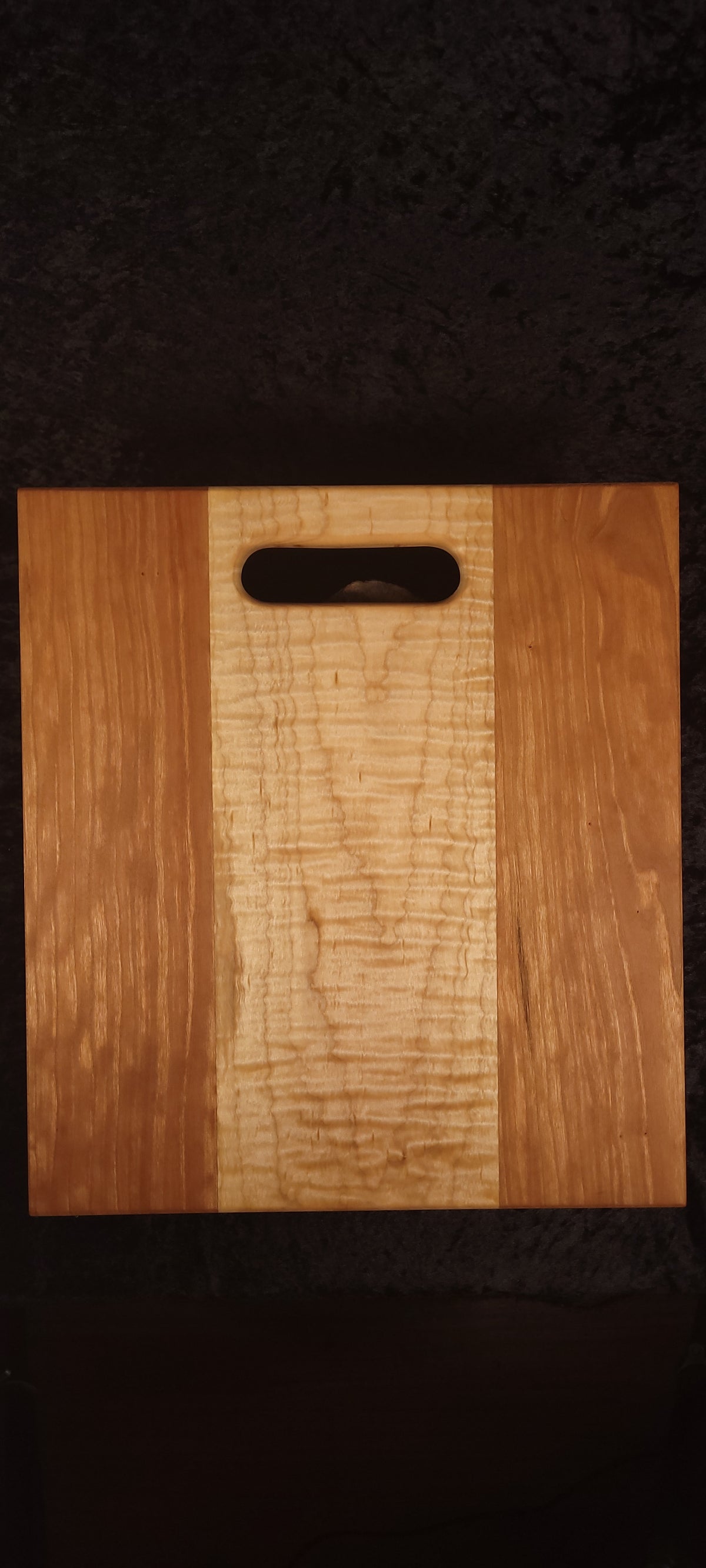 Cherry and curly maple cutting board, reverse side showing grain detail