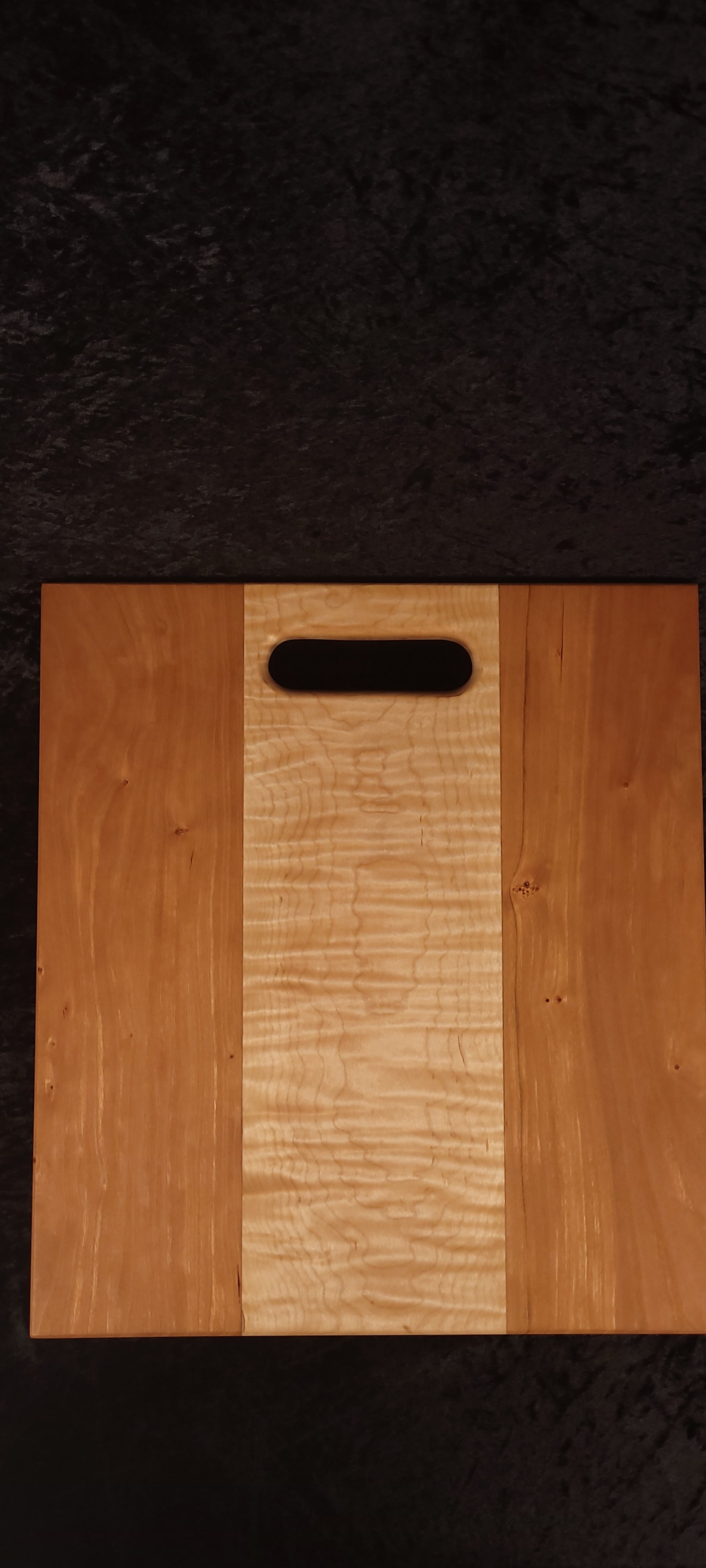 Cherry and curly maple cutting board face showing clean curly maple center stripe