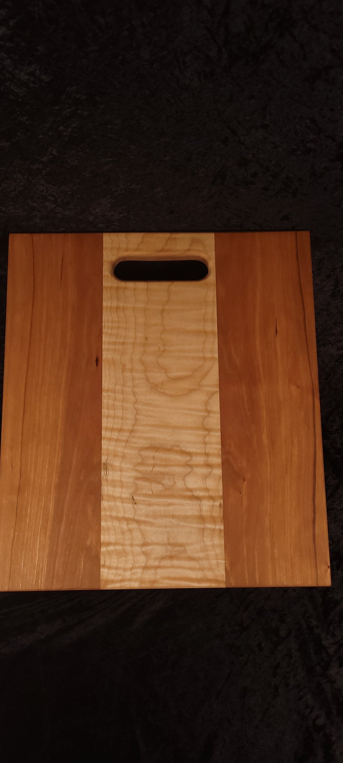 Cherry and curly maple cutting board face, alternate angle showing straight cherry grain