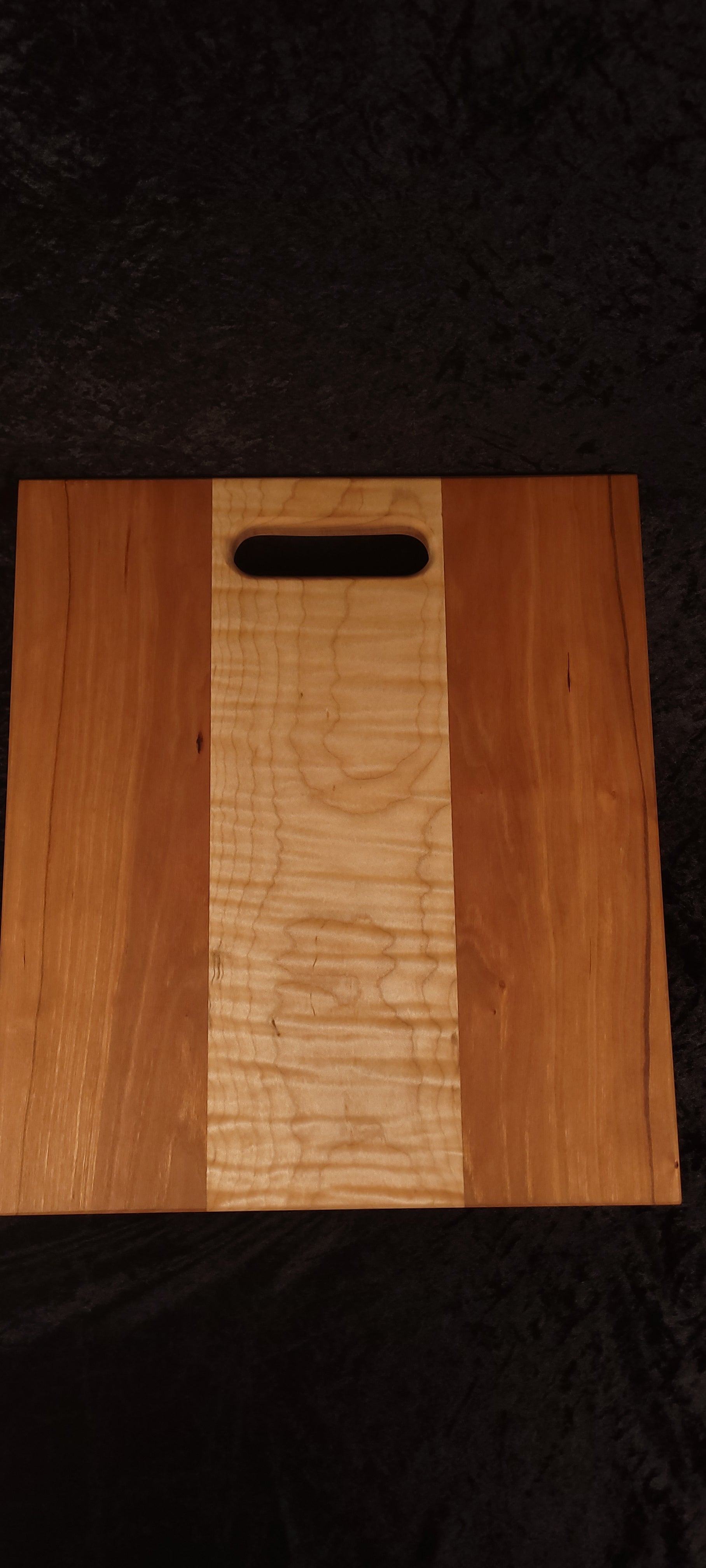 Cherry and curly maple cutting board face, alternate angle showing straight cherry grain