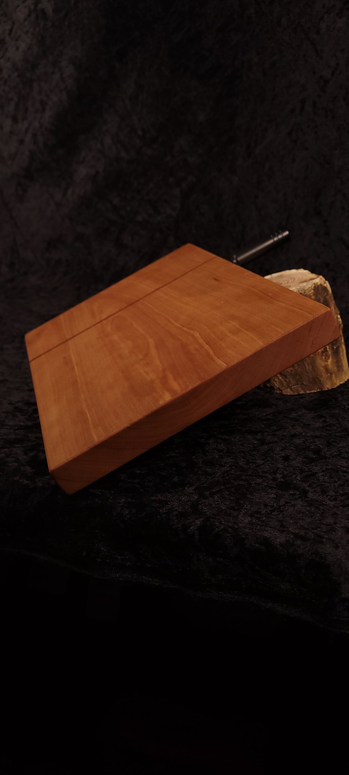 Cherry cheese board angled view with black hardware and wood slice