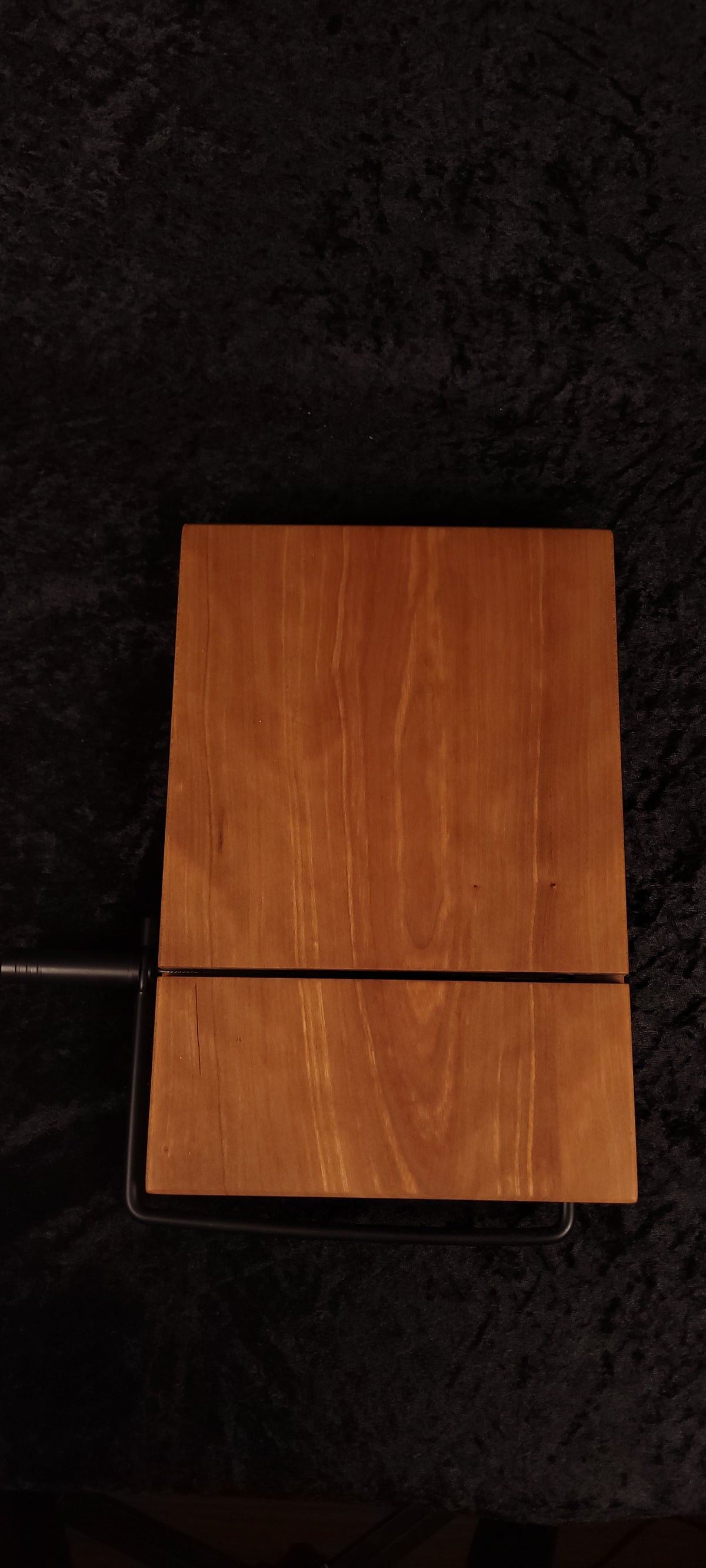 Cherry cheese board top view with black wire cutter