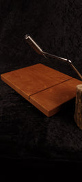 Cherry cheese board top view with stainless wire cutter
