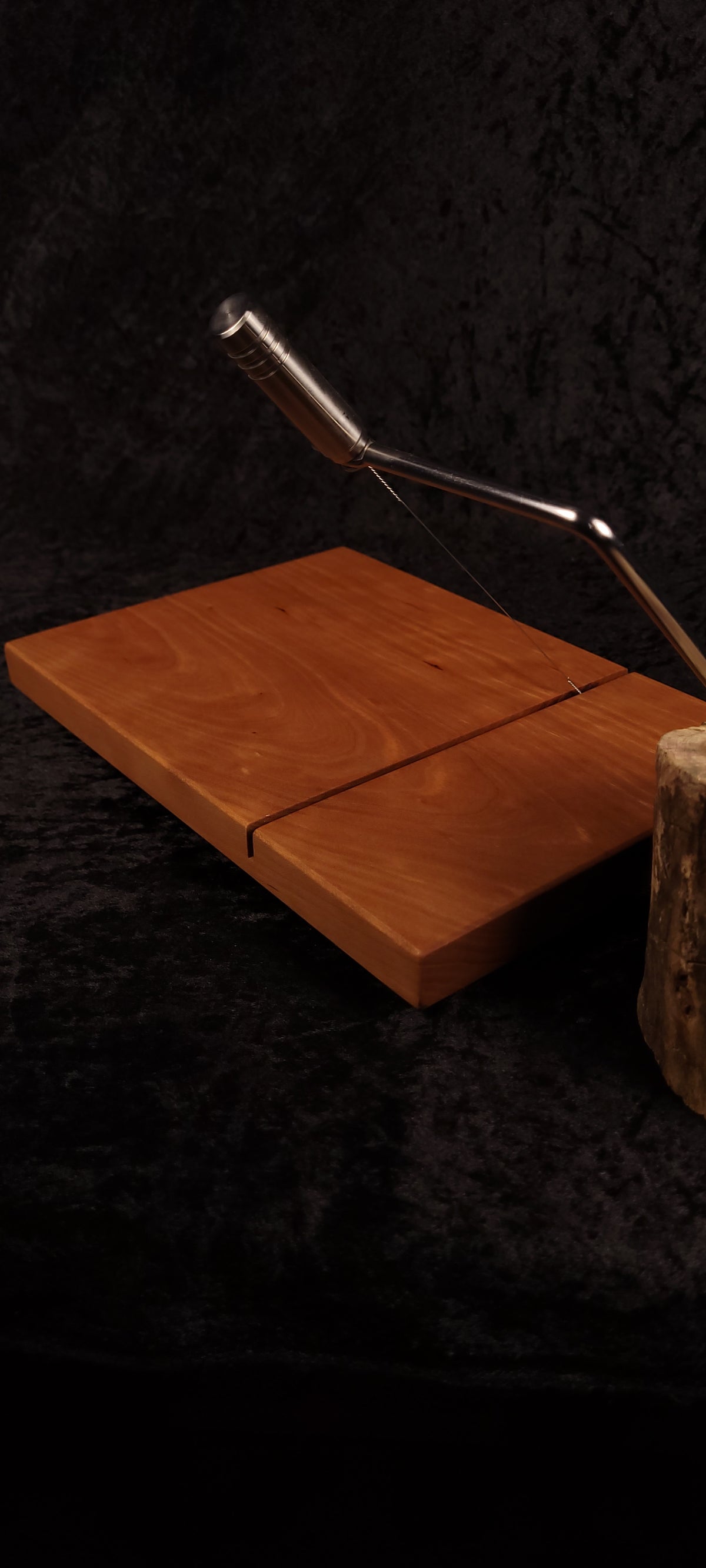Cherry cheese board top view with stainless wire cutter