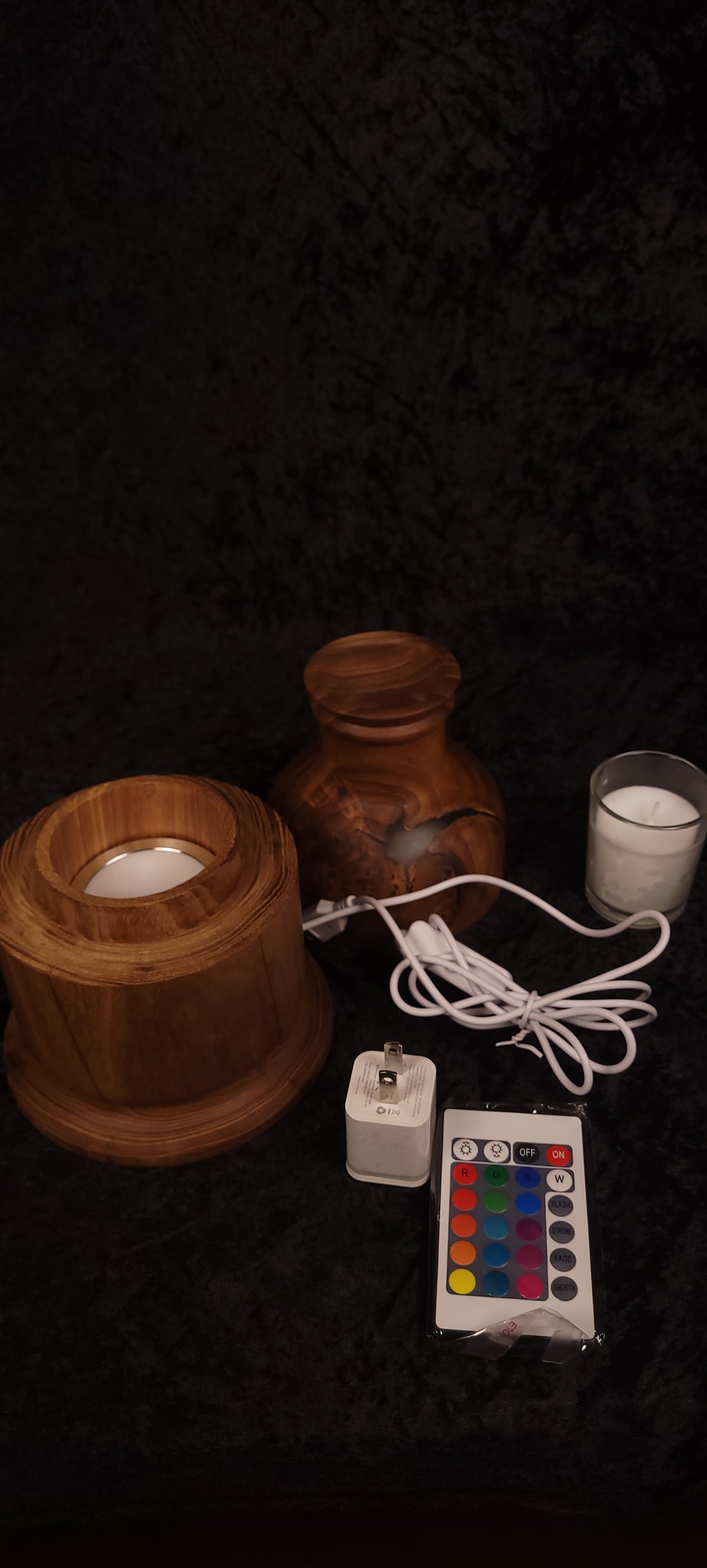 Elm candle lamp disassembled showing base, body, glass candle cup, RGB module, remote, and power adapter
