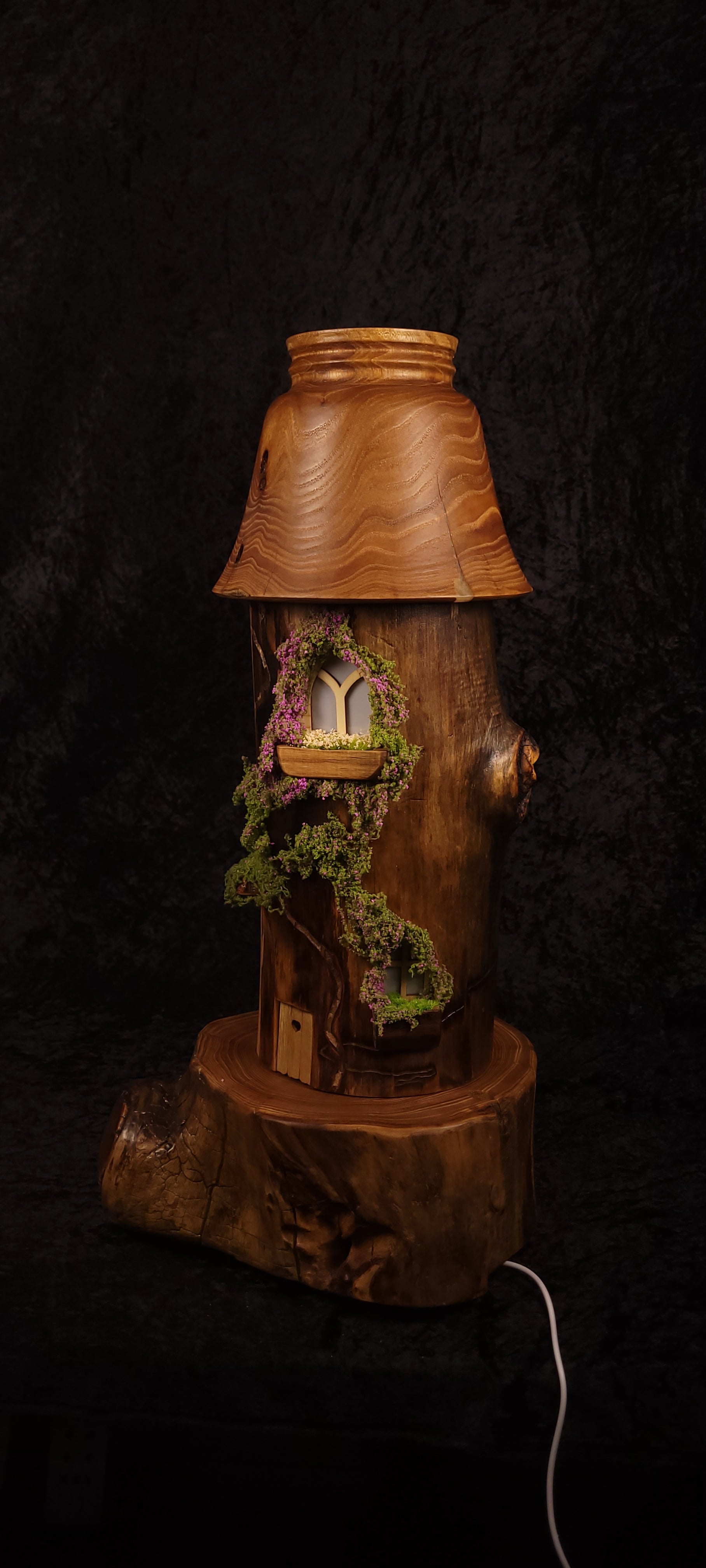 Fairy tower lamp lit with green glow, showing aspen body with moss and miniature window
