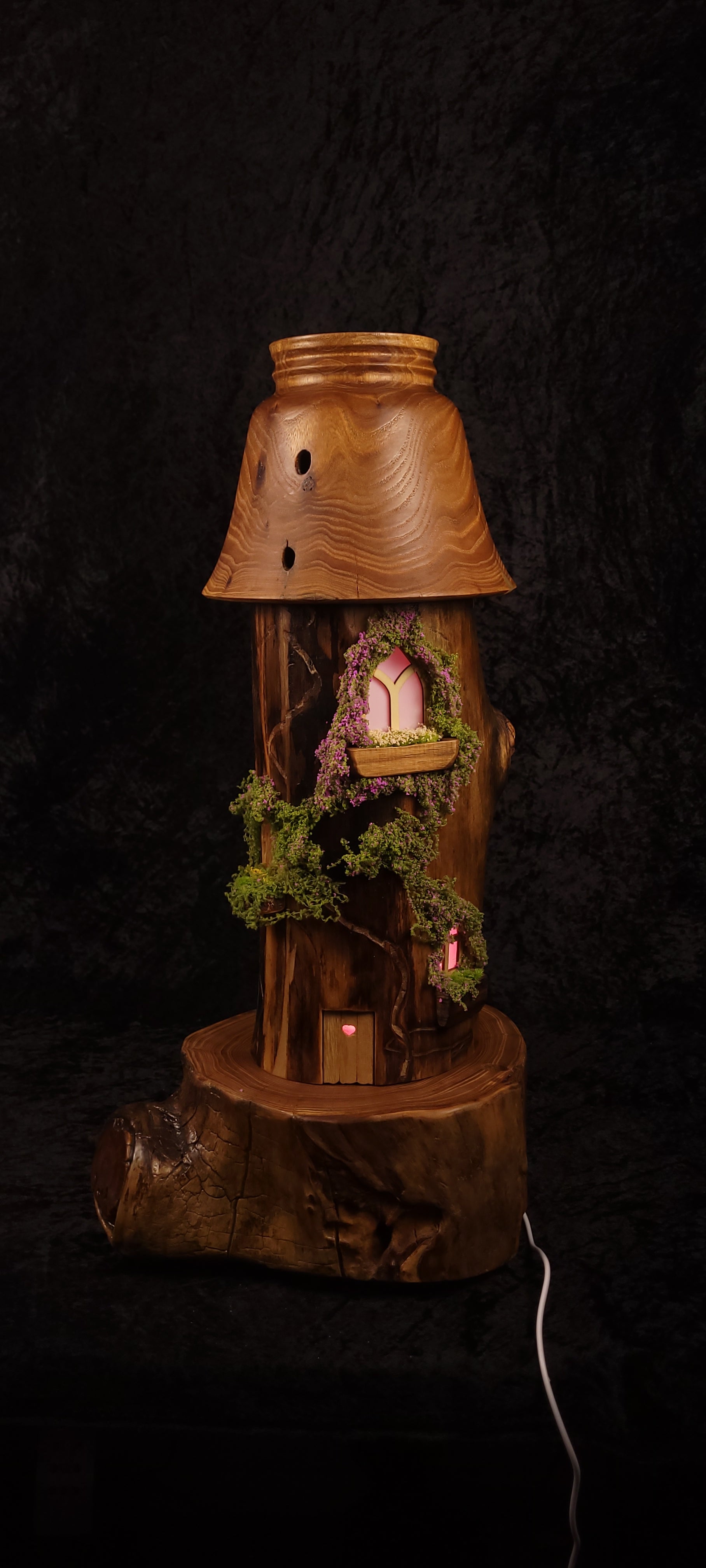 Fairy tower lamp lit showing window with red candles on balcony