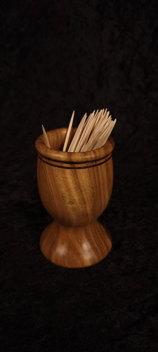 Elm wood toothpick holder filled with toothpicks, front view