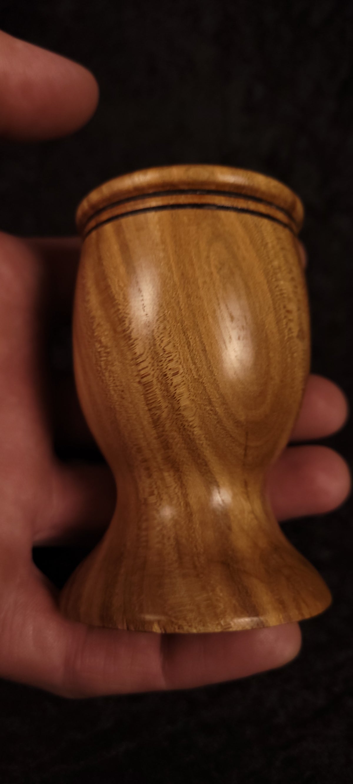 Elm wood toothpick holder held in hand showing scale