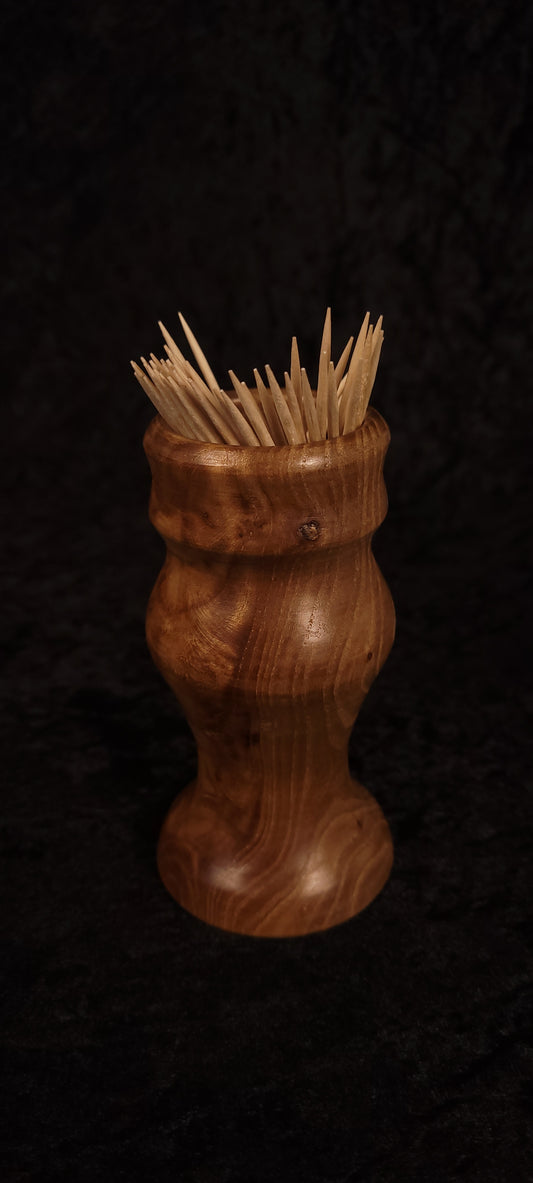 Elm wood toothpick holder filled with toothpicks, front view