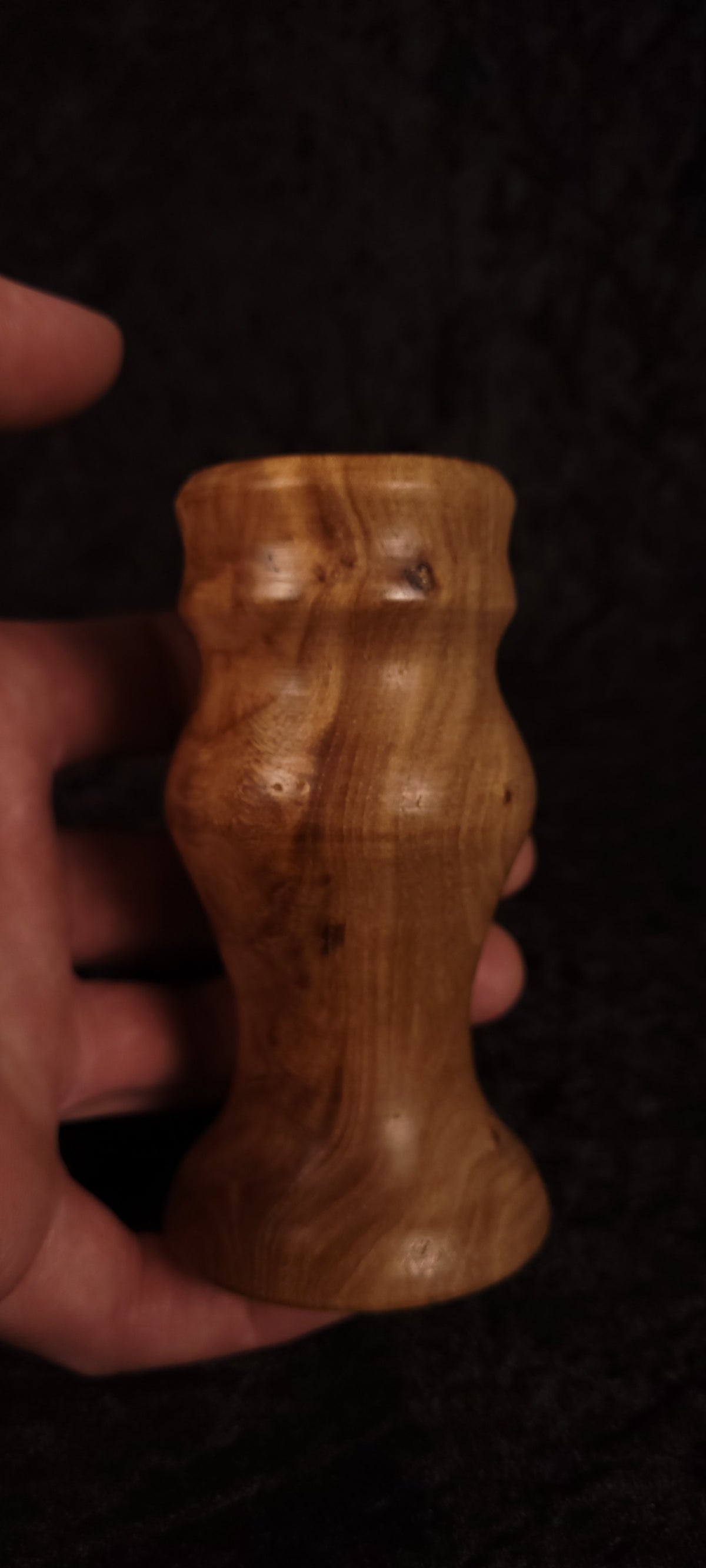 Elm wood toothpick holder held in hand showing scale