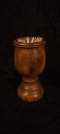 Elm wood toothpick holder filled with toothpicks, front view