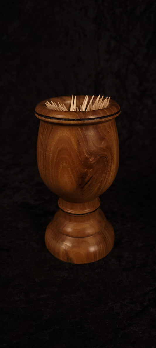 Elm wood toothpick holder filled with toothpicks, front view