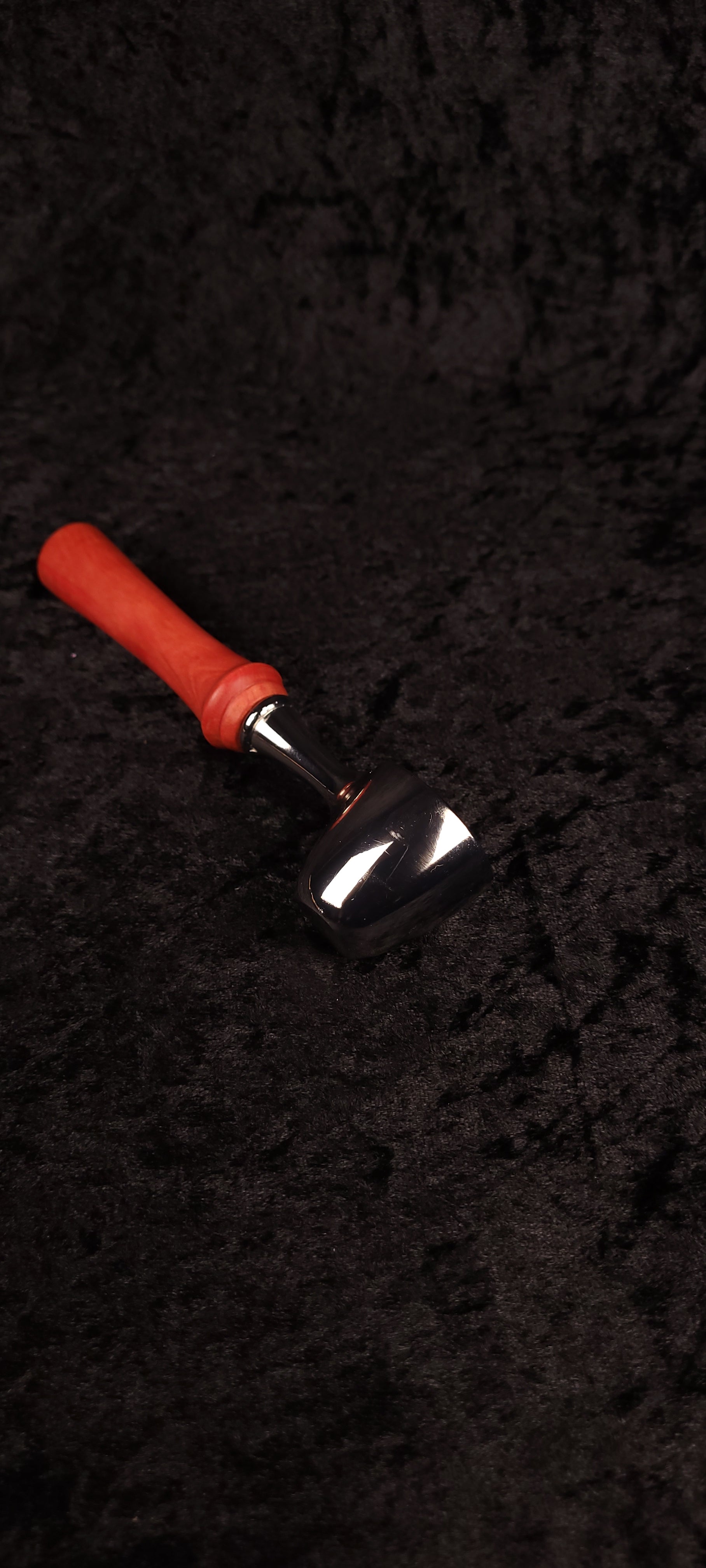 Pink Ivory wood coffee scoop held in hand showing chrome scoop detail