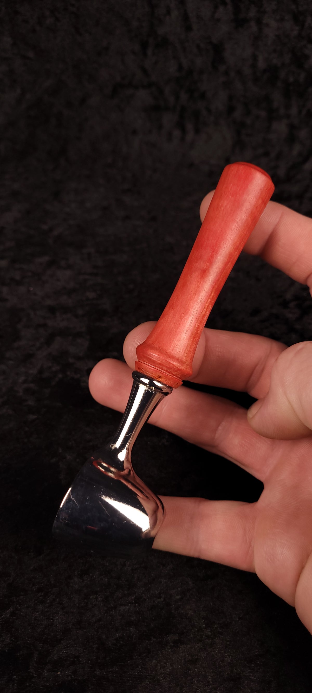 Pink Ivory wood coffee scoop standing upright showing handle profile