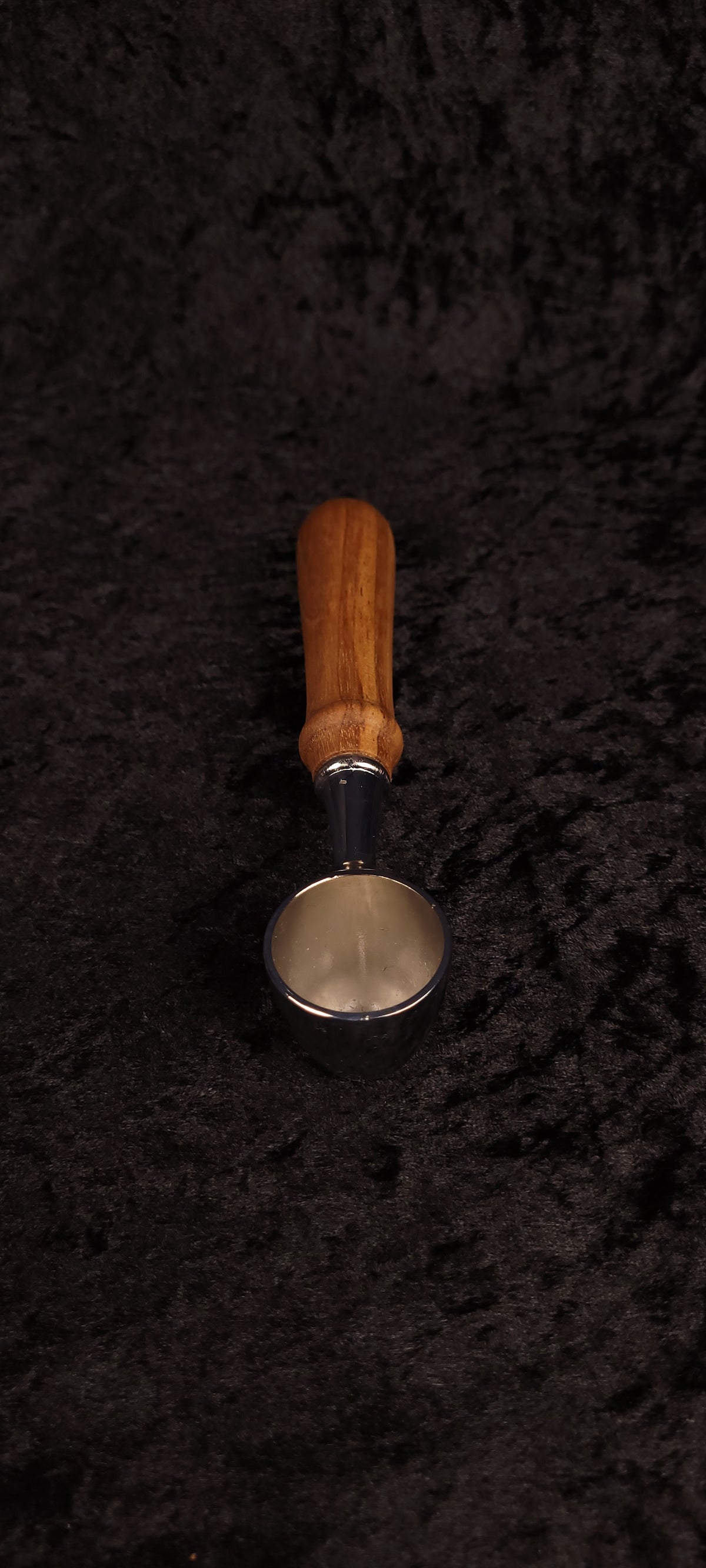 Walnut coffee scoop upright view showing chrome scoop face and handle