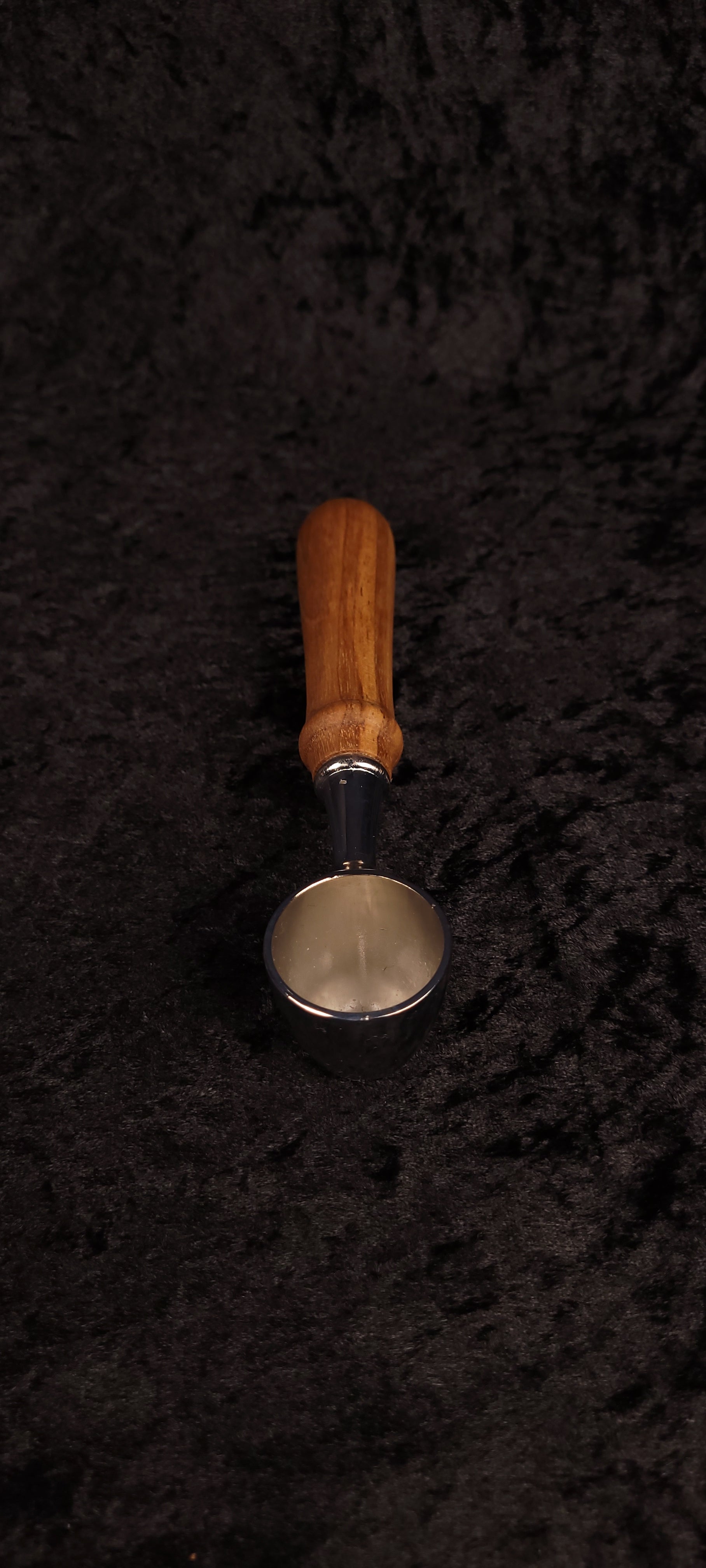 Walnut coffee scoop upright view showing chrome scoop face and handle