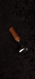Walnut coffee scoop No. 2 angled view on black background showing chrome dome and warm brown handle