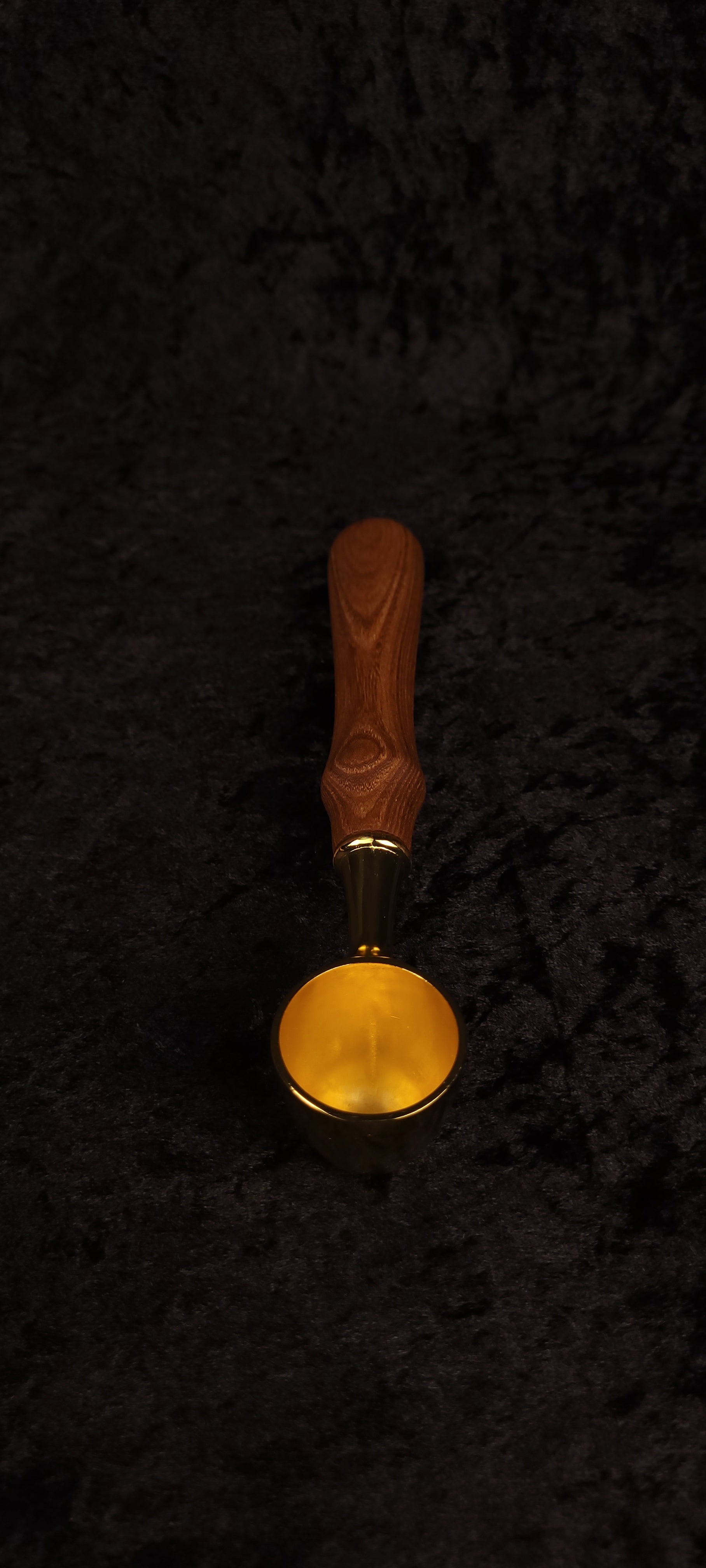 Catalpa wood coffee scoop top-down view showing gold scoop face and full handle length
