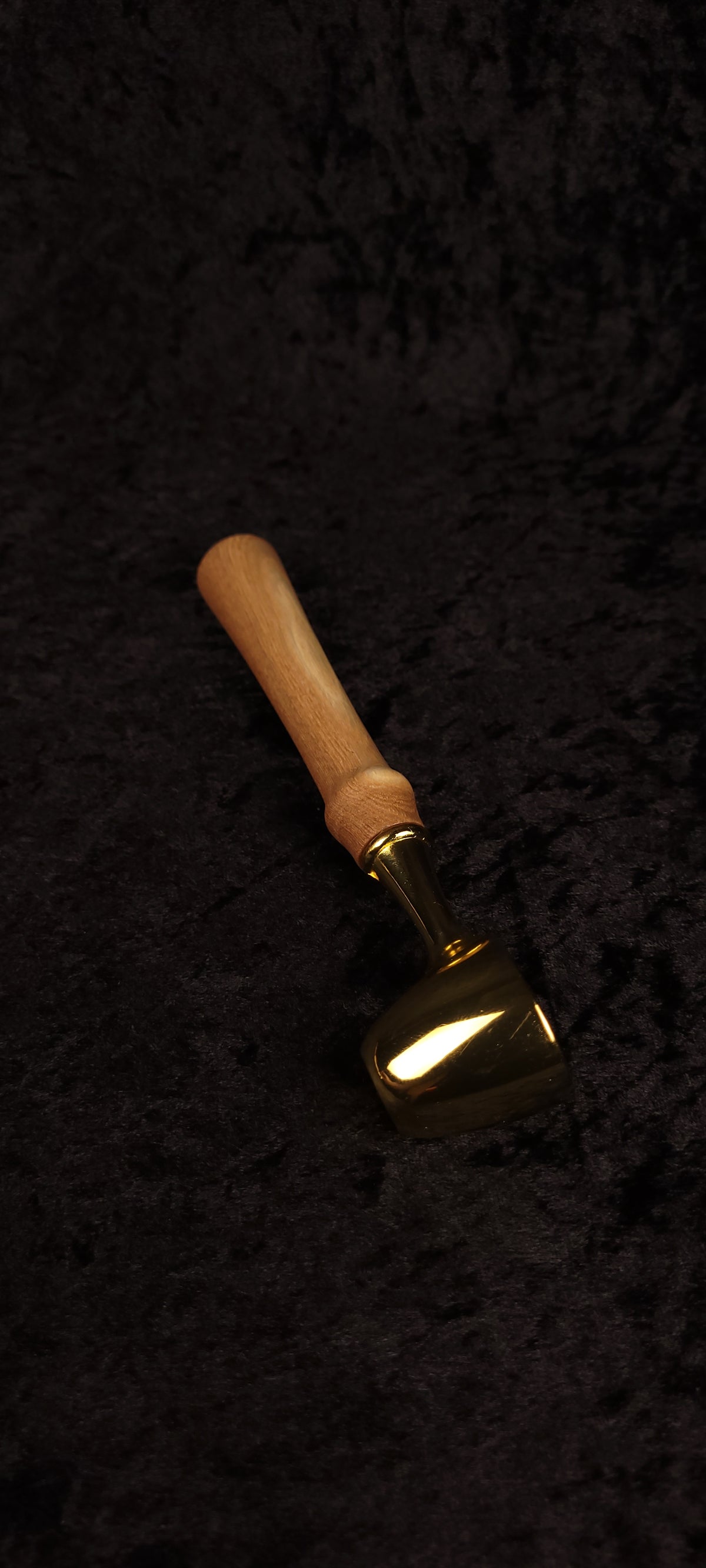 Catalpa wood coffee scoop No. 2 diagonal view on black background showing gold dome scoop and tapered honey-brown handle