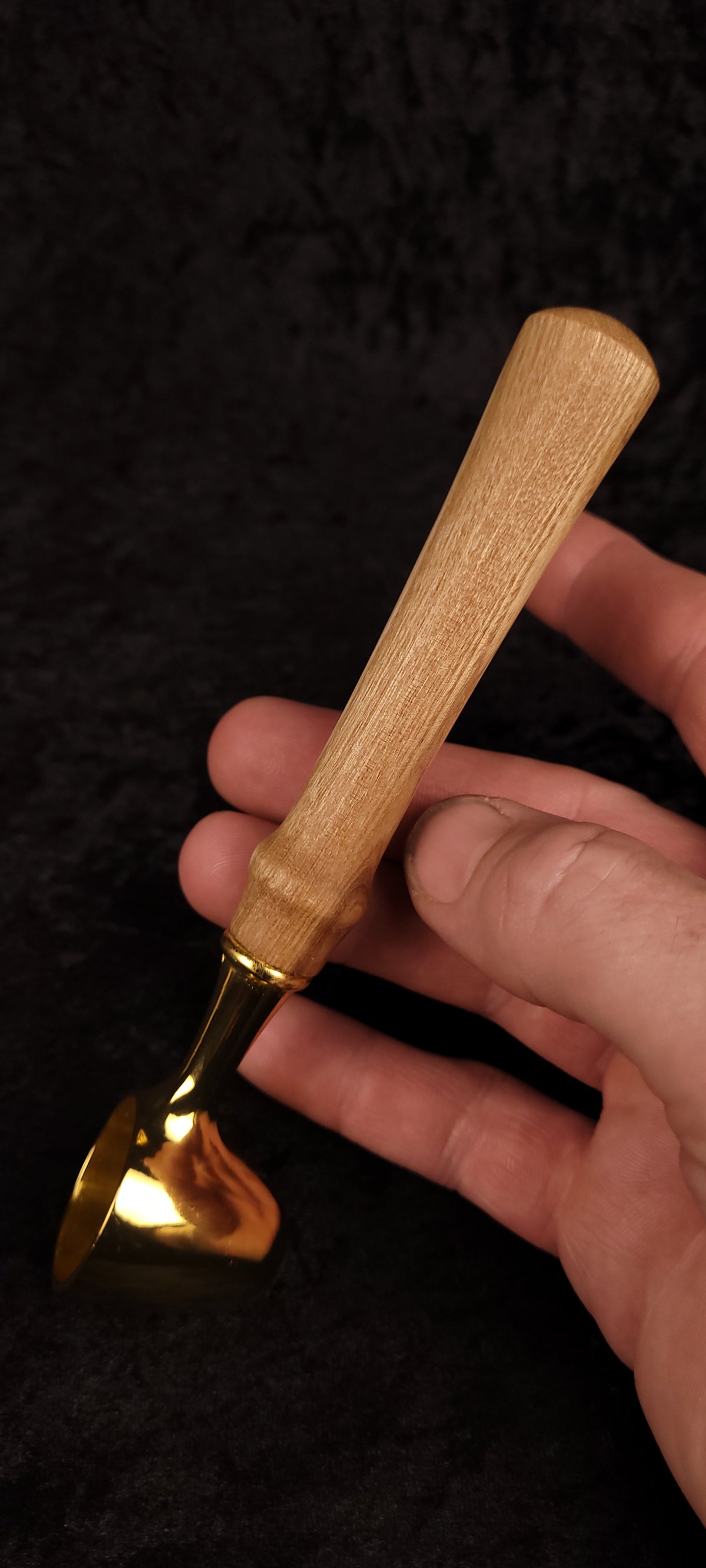 Catalpa wood coffee scoop No. 2 held in hand showing scale, gold scoop and tapered Catalpa handle