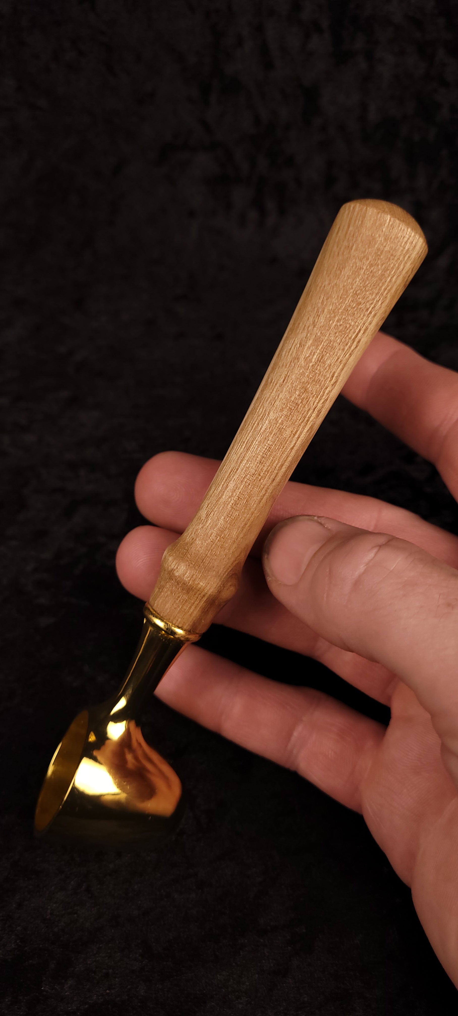 Catalpa wood coffee scoop No. 2 held in hand showing scale, gold scoop and tapered Catalpa handle