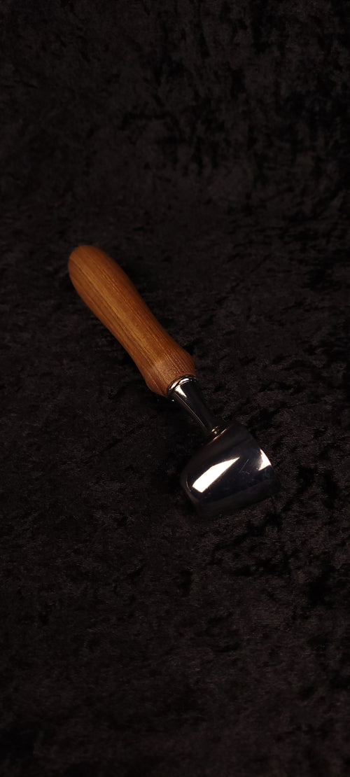Catalpa wood coffee scoop No. 3 diagonal view on black background showing chrome dome scoop and elongated oval honey-brown handle