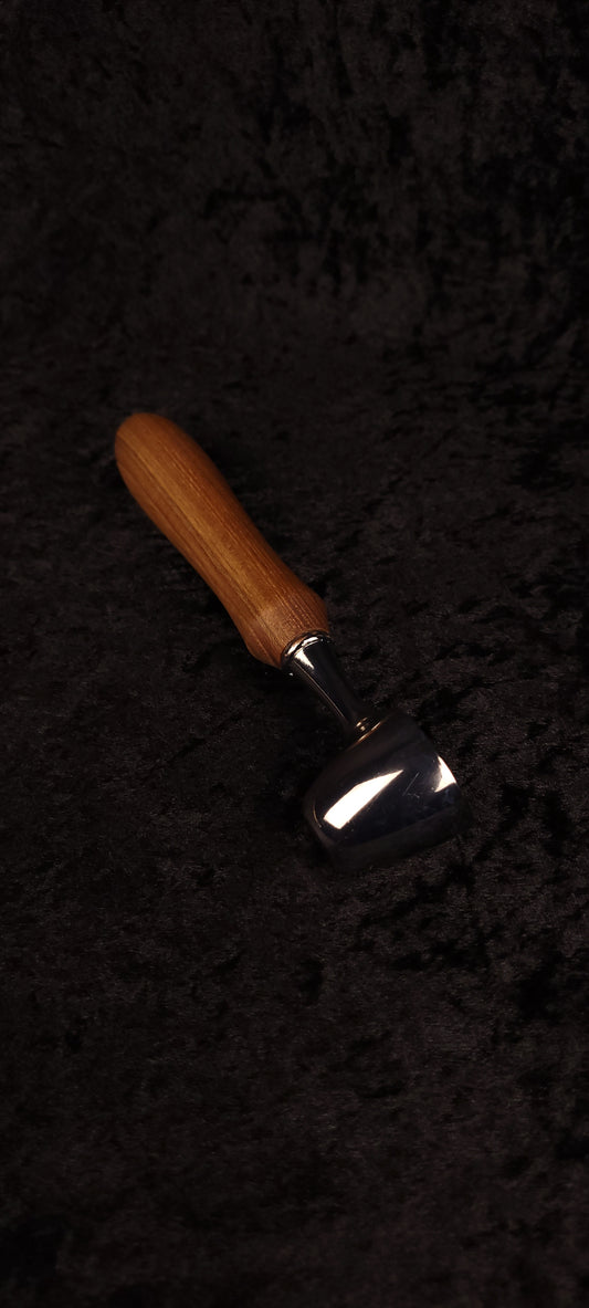 Catalpa wood coffee scoop No. 3 diagonal view on black background showing chrome dome scoop and elongated oval honey-brown handle