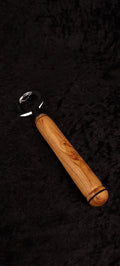 Locust wood bottle opener on dark background