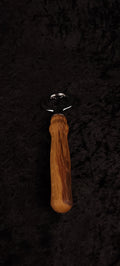 Oak wood bottle opener on dark background, top view