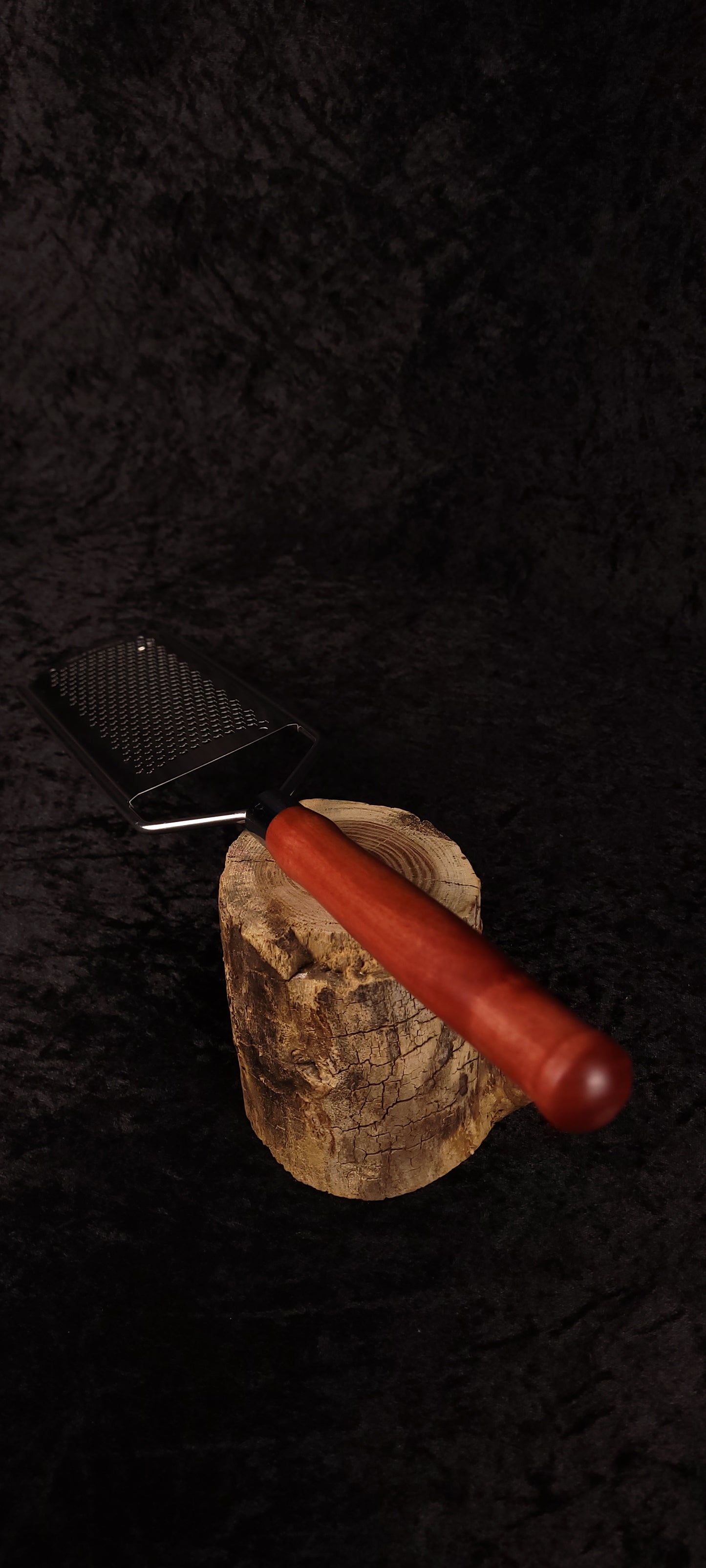 Pink Ivory handle rasp grater displayed on wood round
