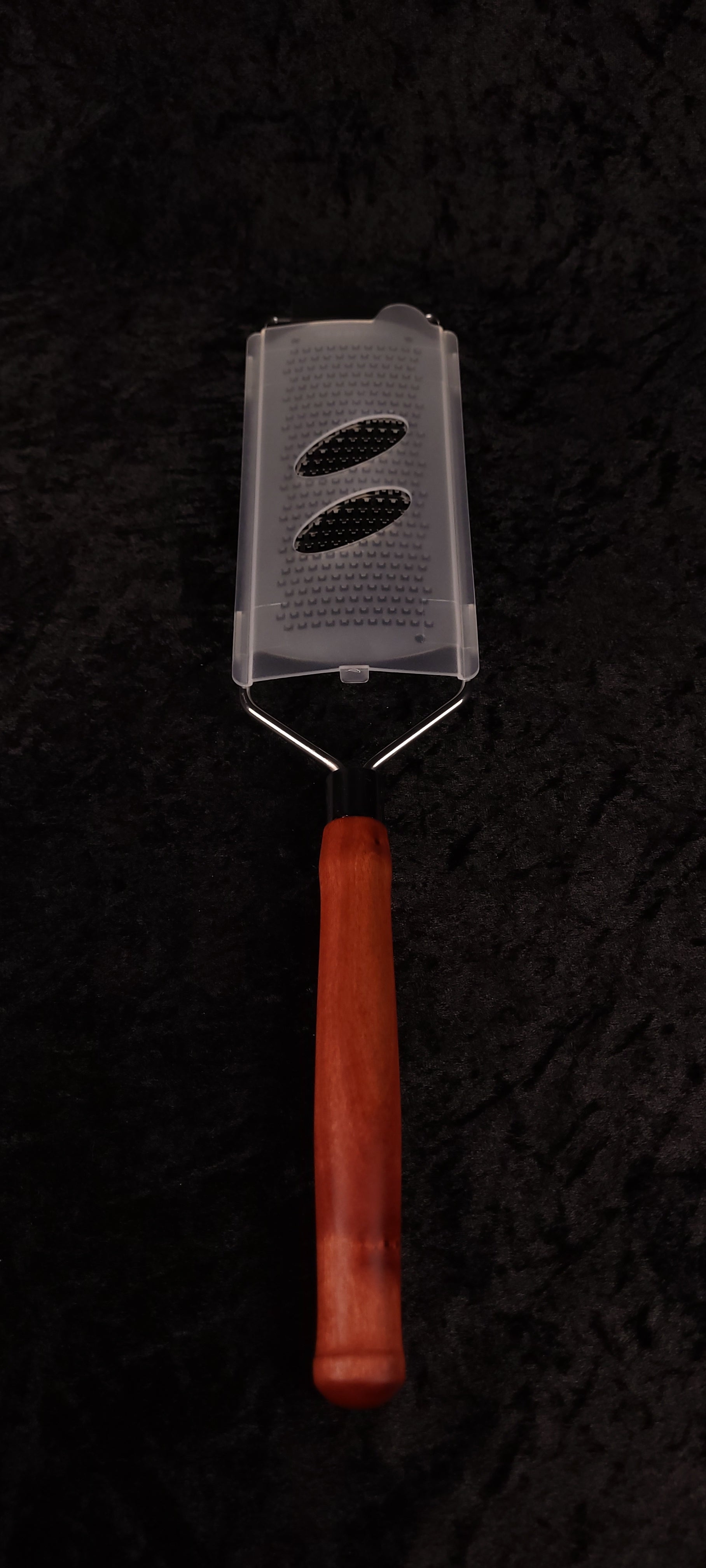 Pink Ivory handle rasp grater on wood round side view