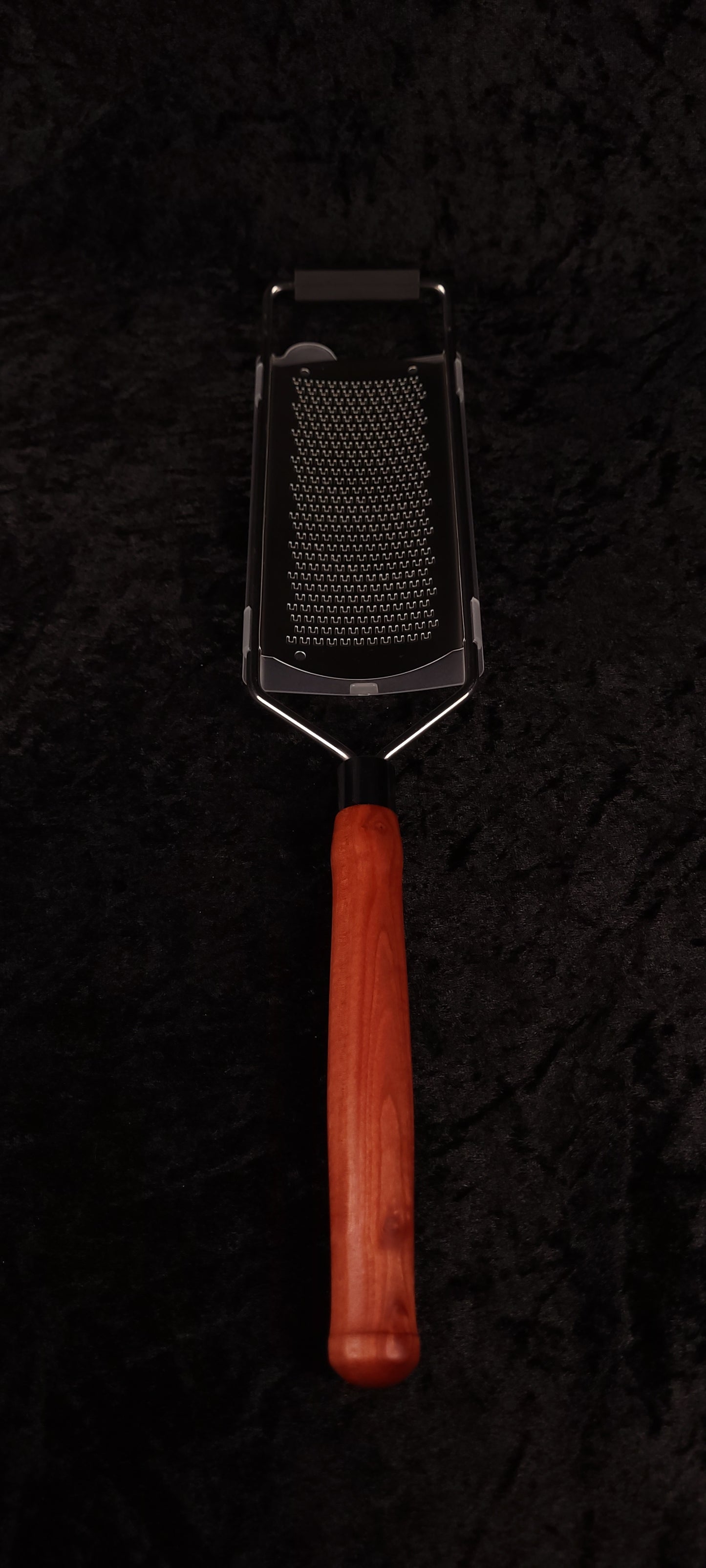 Hand holding Pink Ivory handle rasp grater