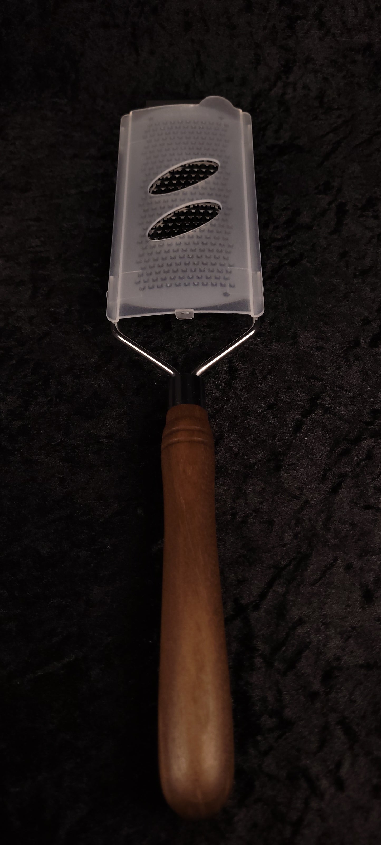 Walnut rasp grater with protective cover, handle down