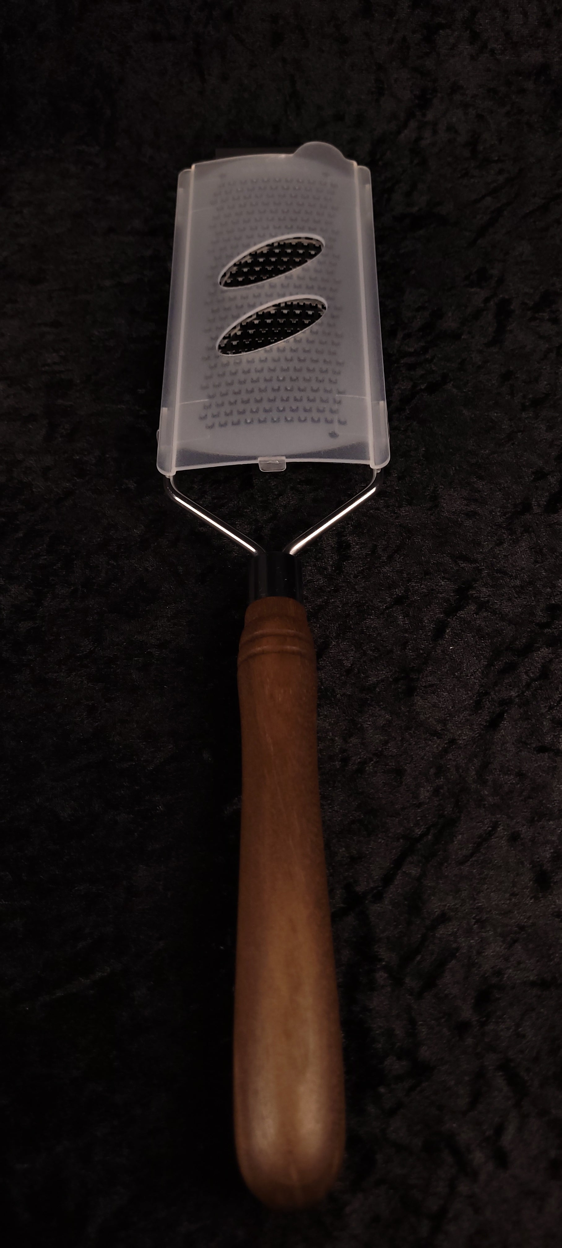 Walnut rasp grater with protective cover, handle down