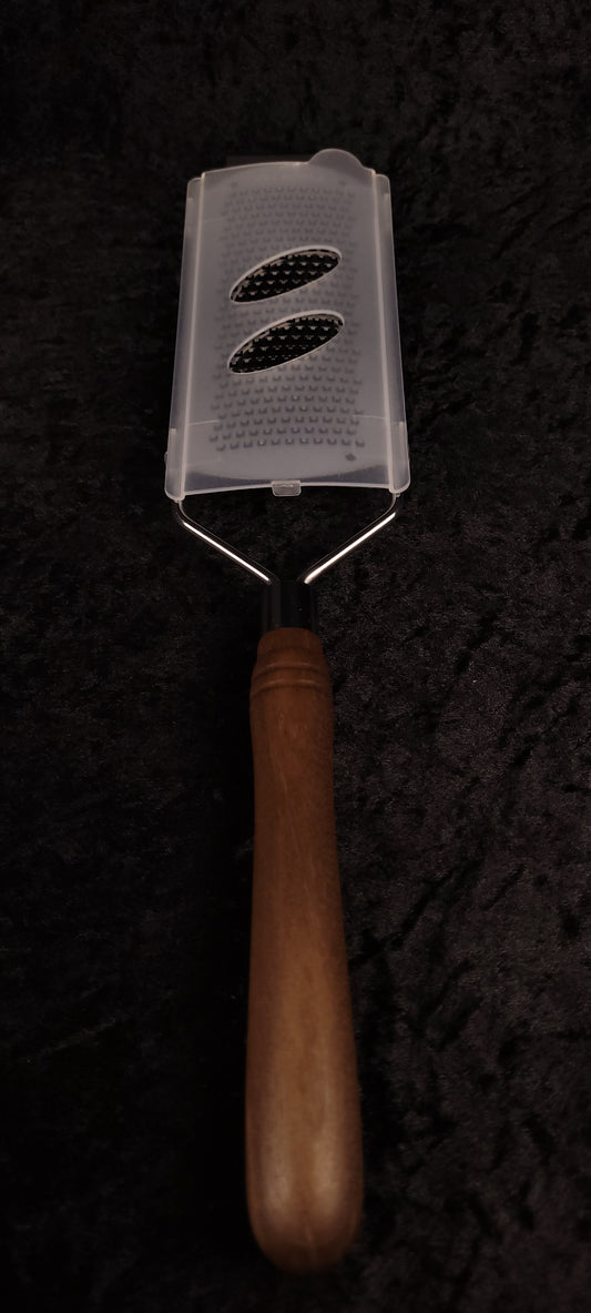 Walnut rasp grater with protective cover, handle down