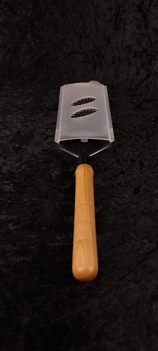 Curly maple rasp grater without guard showing rasp surface, top-down