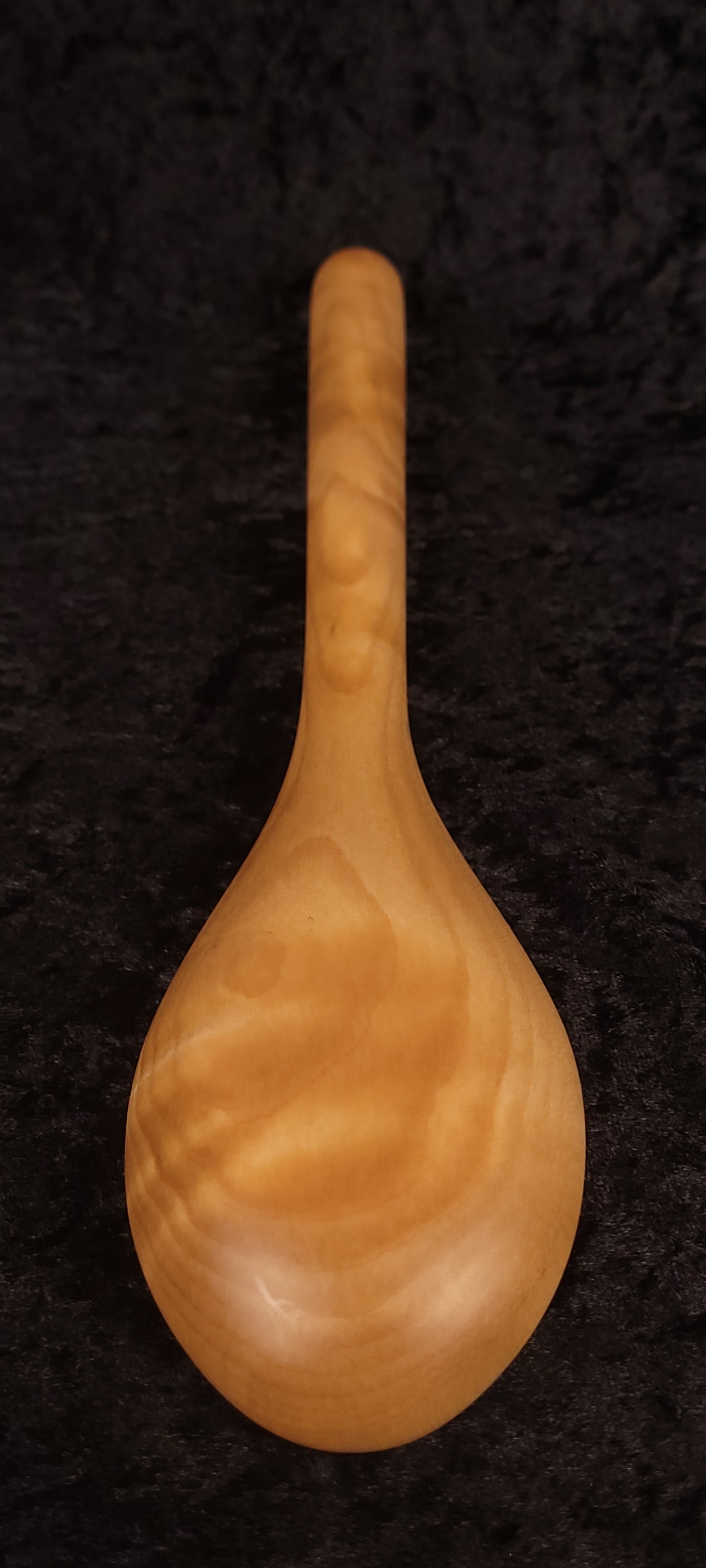 Curly maple spoon back view showing chunky handle and ball end