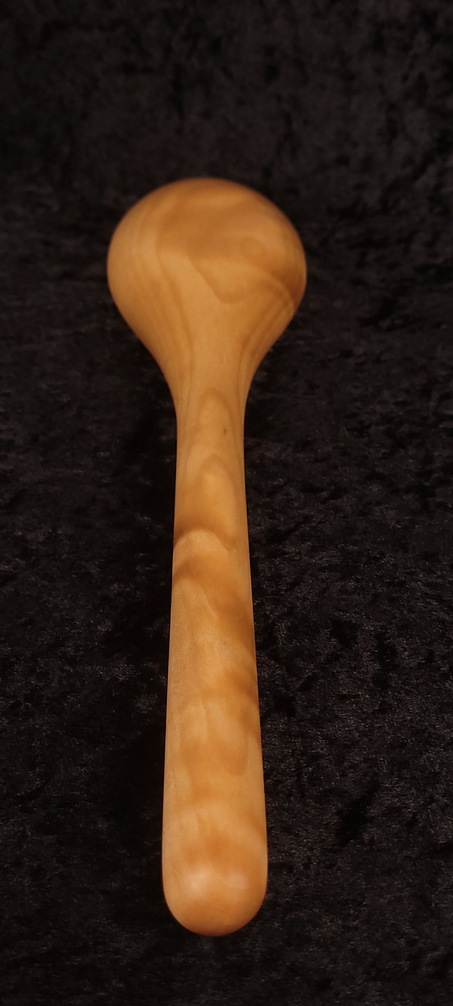 Curly maple spoon front view showing bowl depth and swirling grain